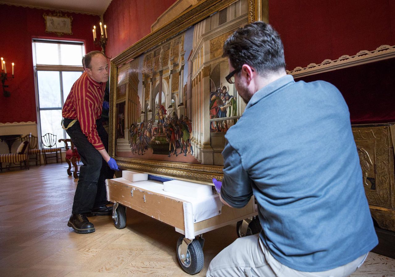 Art handler John Peitso, left, and collections care associate Matthew Del Grosso carefully load Botticelli's "The Tragedy of Lucretia" onto a cart for its short journey to the new building at the museum for an upcoming exhibition. (Robin Lubbock/WBUR)
