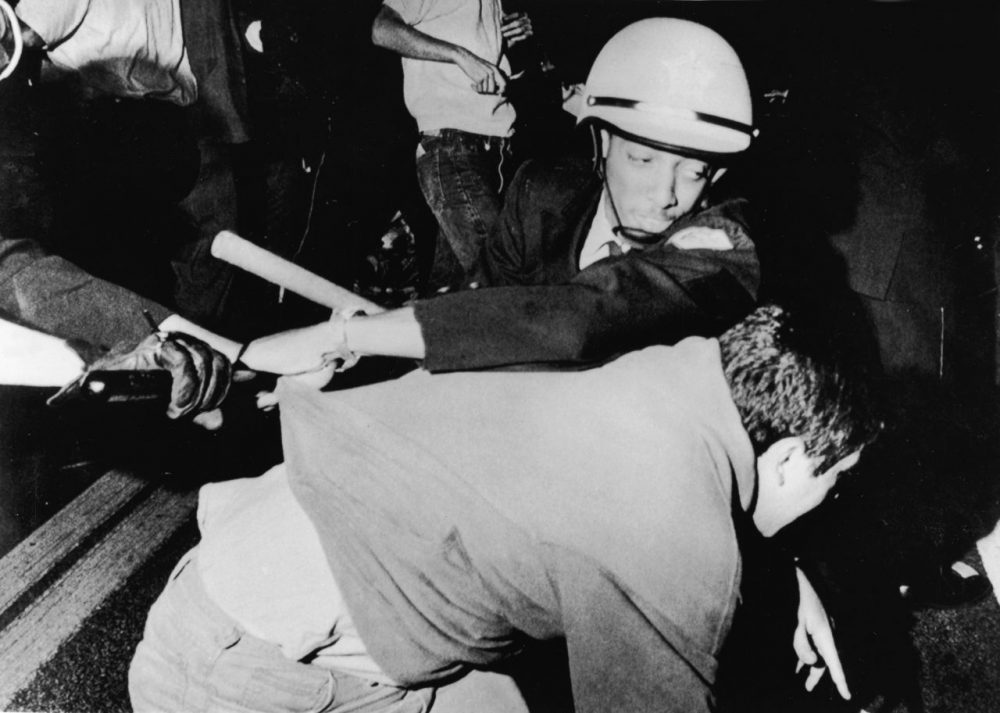 An officer from the Chicago Police Department struggles with an antiwar demonstrator outside Democratic headquarters at the Hilton Hotel on Michigan Avenue as demonstrators attempt to break through police lines to move the protest to the 1968 Democratic National Convention, being held five miles away at the International Amphitheatre, Chicago, Illinois, August 28, 1968. (APA/Getty Images)