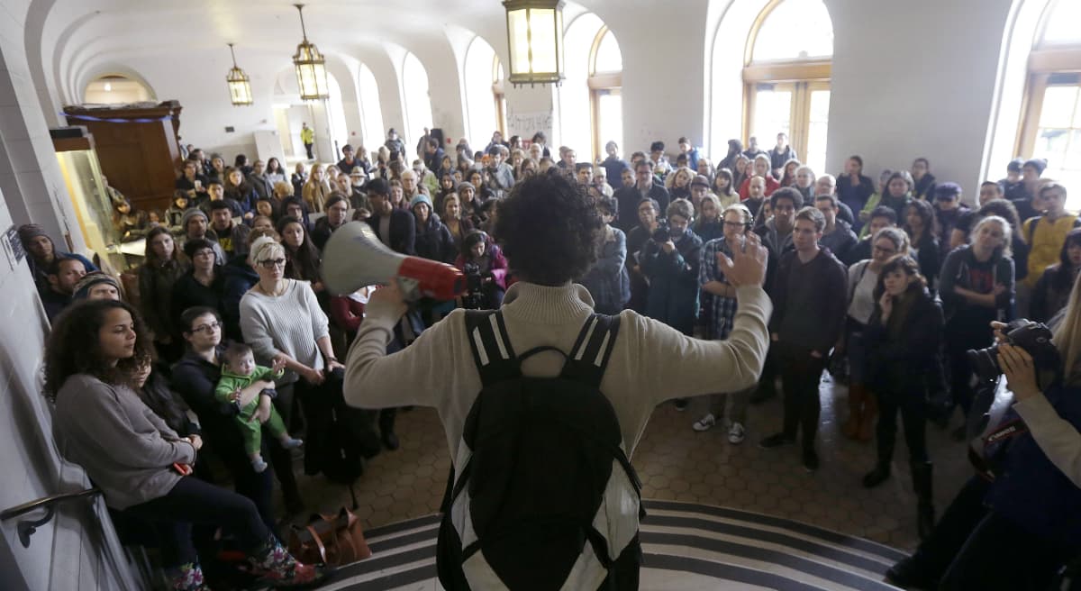 Students, faculty and supporters listen to a speaker during a rally protesting a series of tuition increases at the University of California, Berkeley, Tuesday, Dec. 2, 2014. (Jeff Chiu/AP)