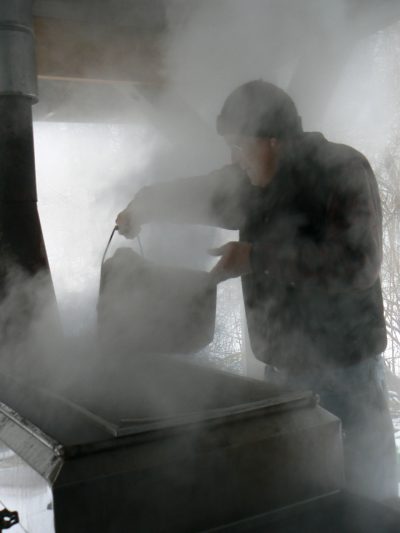 A worker boils maple sap down to syrup inside a sugar shack at Drumlin Farm Wildlife Sanctuary. (Courtesy Mass Audubon)