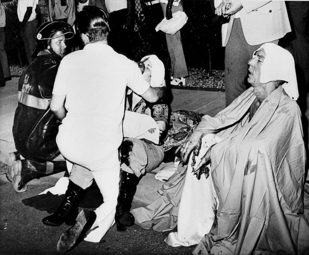 Firemen give first aid to survivors of a French Quarter fire that swept through a second story bar leaving 29 dead and 15 injured, June 25, 1973, in New Orleans. Several persons leaped to safety before the entire bar was engulfed in flames. (G.E. Arnold/AP)