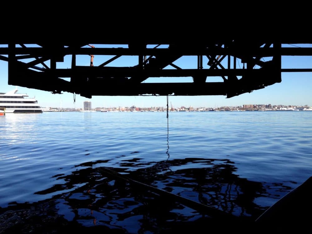 The underbelly of the Northern Avenue Bridge is rusting. (Virginia Marshall for WBUR)