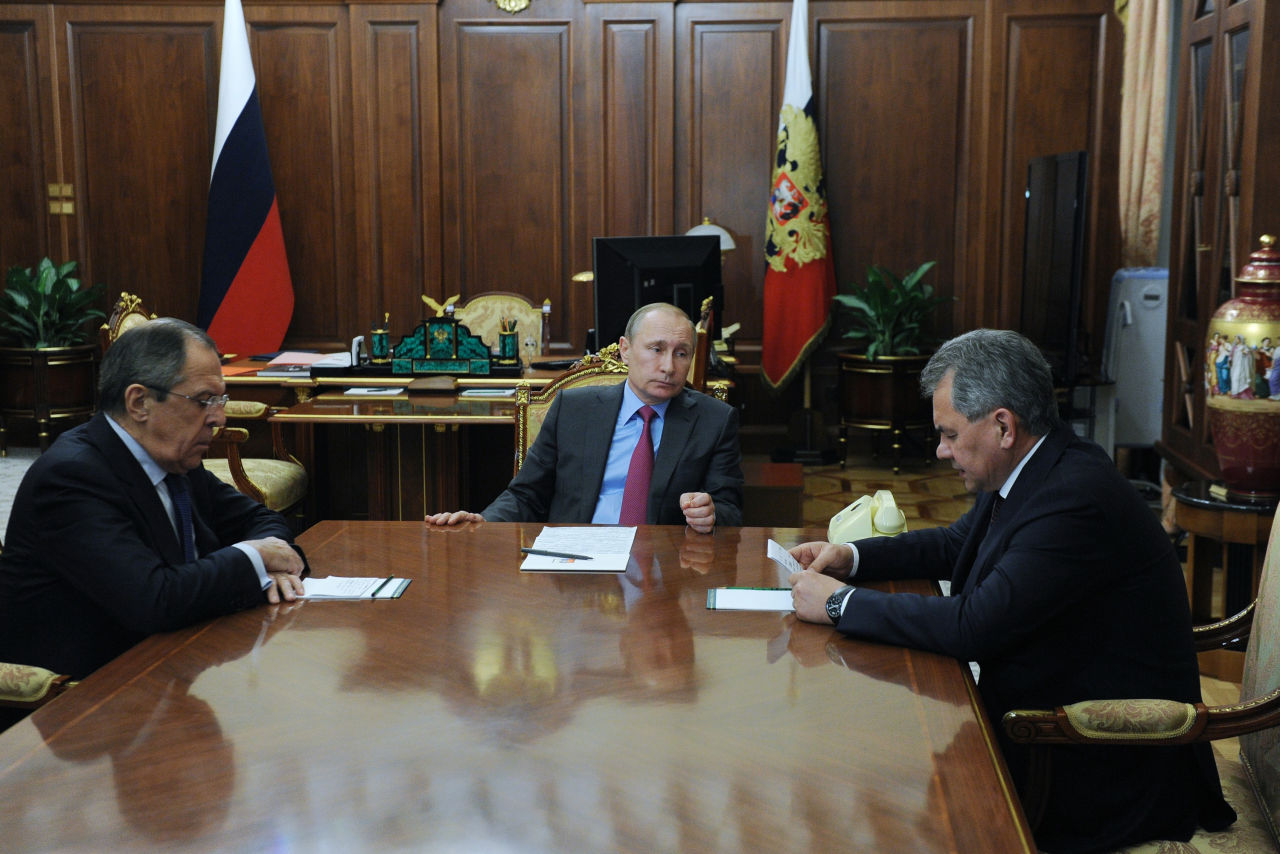 Russian President Vladimir Putin, center, Russian Foreign Minister Sergey Lavrov, left, and Russian Defense Minister Sergey Shoygu, right, speak during their meeting in the Kremlin in Moscow, Russia, Monday, March 14, 2016. Russian President Vladimir Putin has ordered the start of the pullout of the Russian military from Syria starting Tuesday. (Mikhail Klimentyev/Sputnik, Kremlin Pool Photo via AP)