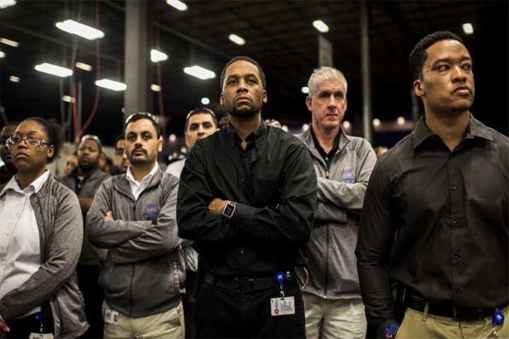 Workers at Detroit Manufacturing Systems, an auto-parts company in Detroit, await a visit by Hillary Clinton on March 4. (Melina Mara/The Washington Post)