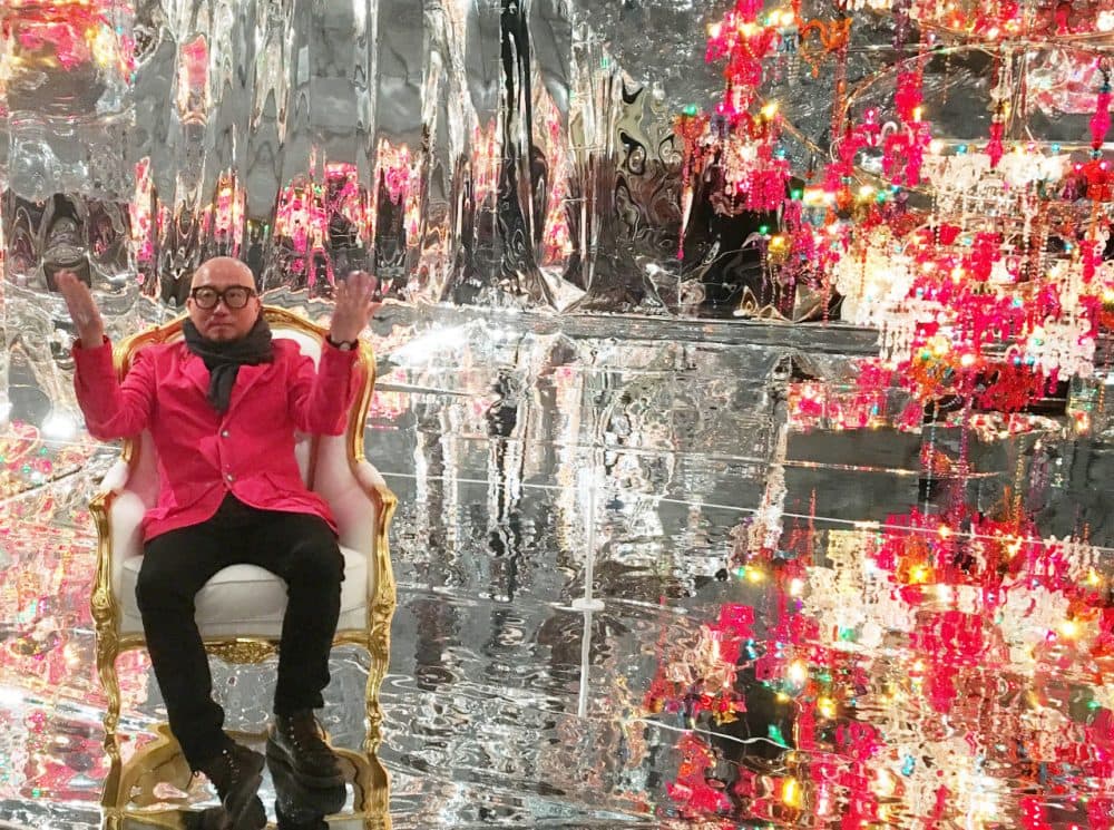 Choi Jeong Hwa sits in his &quot;Chaosmos Mandala&quot; at the MFA that invites visitors to pull up a chair and share photos on social media to become part of the art. (Andrea Shea/WBUR)