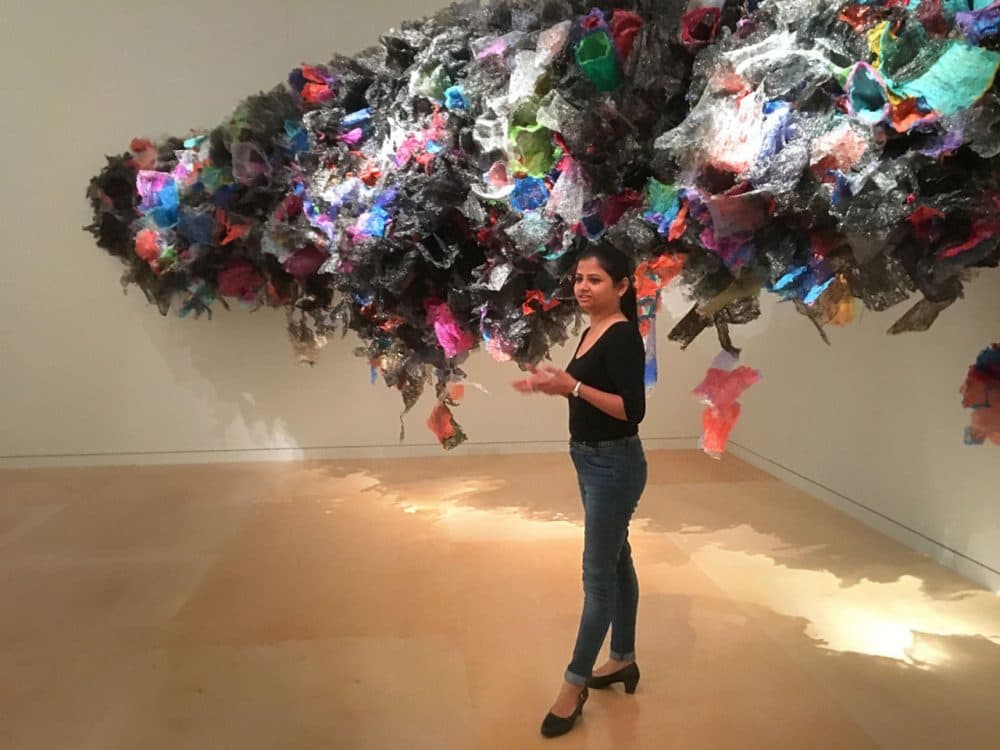 Aaditi Joshi with her installation in the Museum of Fine Arts. (Andrea Shea/WBUR)
