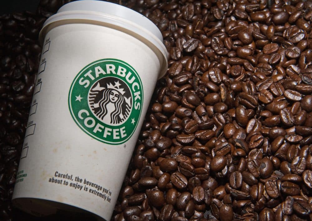 A Starbucks coffee cup and beans are seen in this photo taken August 12, 2009 in Washington, DC.  (Paul J. Richards/AFP/Getty Images)