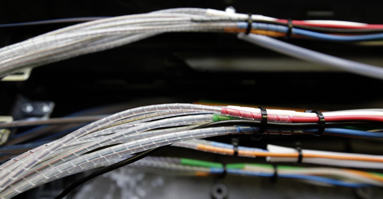 Verizon is now bringing the high speed Internet and cable television competition it already offers in other parts of Massachusetts to Boston. Pictured: Glass fibers, housed inside narrow cables, are seen as they're being connected to the Verizon Fios fiber network in Rockville, Maryland. (Alex Brandon/AP)