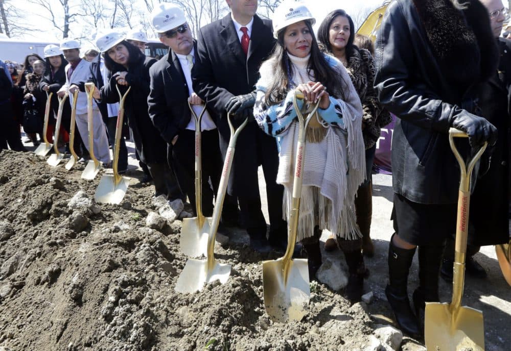 Tribal Council member Winnie Johnson Graham holds a shovel along with others during Tuesday's groundbreaking of the Mashpee Wampanoag tribe's casino. (Elise Amendola/AP)