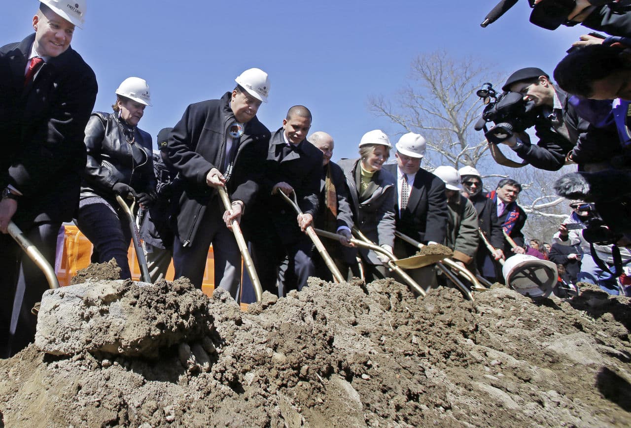 Taunton Mayor Thomas Hoye, far left, Tribal Chairman Cedric Cromwell, third from left, and others wield shovels during an official groundbreaking on Tuesday where the Mashpee Wampanoag tribe will build a resort casino. (Elise Amendola/AP)