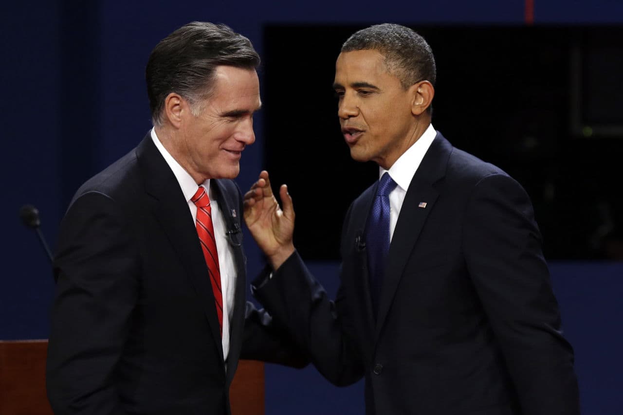 In this Oct. 3, 2012 file photo, Republican presidential candidate former Massachusetts Gov. Mitt Romney and President Obama talk after the first presidential debate at the University of Denver in Denver. (Charlie Neibergall/AP)