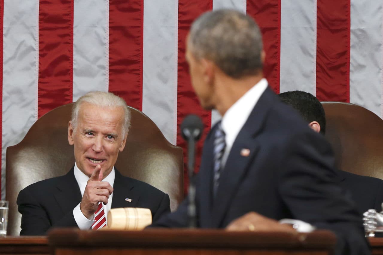In this Jan. 12, 2016 file-pool photo, Vice President Joe Biden points at President Obama during the president's State of the Union address. That month, harking back to America's triumphant race into space, the Obama administration signed a presidential memorandum establishing what it calls a "moonshot" effort to cure cancer. (Evan Vucci/AP)