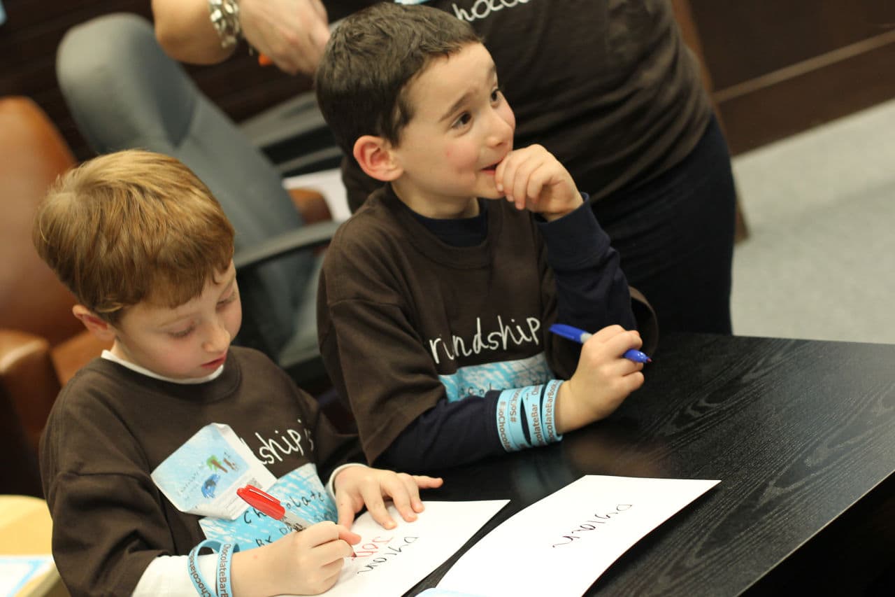Jonah Pournazarian, left, and Dylan Siegel sign copies of Dylan's book. (Courtesy of David Siegel)