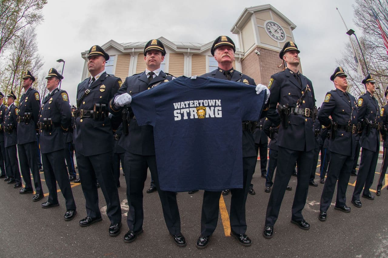 Watertown police officers hold a shirt to be presented to Vice President Joe Biden at MIT Police Officer Sean Collier's memorial service. (Courtesy Joshua Touster)