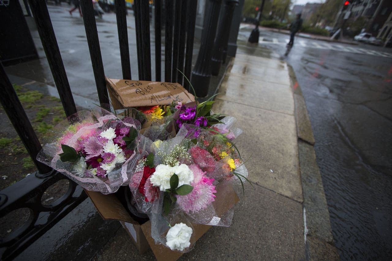 A memorial set up for 28-year-old Allison Warmuth sits in the rain on the corner of Charles and Beacon Streets. (Jesse Costa/WBUR)