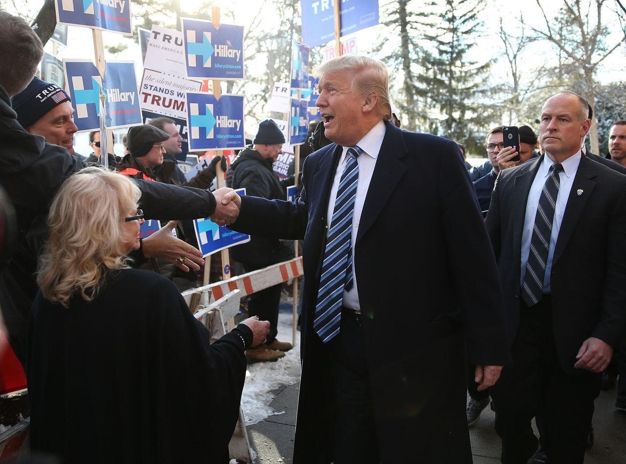 On February 9, 2016, Republican presidential candidate Donald Trump greets people as he visits a polling station as voters cast their primary day ballots in Manchester, New Hampshire. (Joe Raedle/Getty Images)