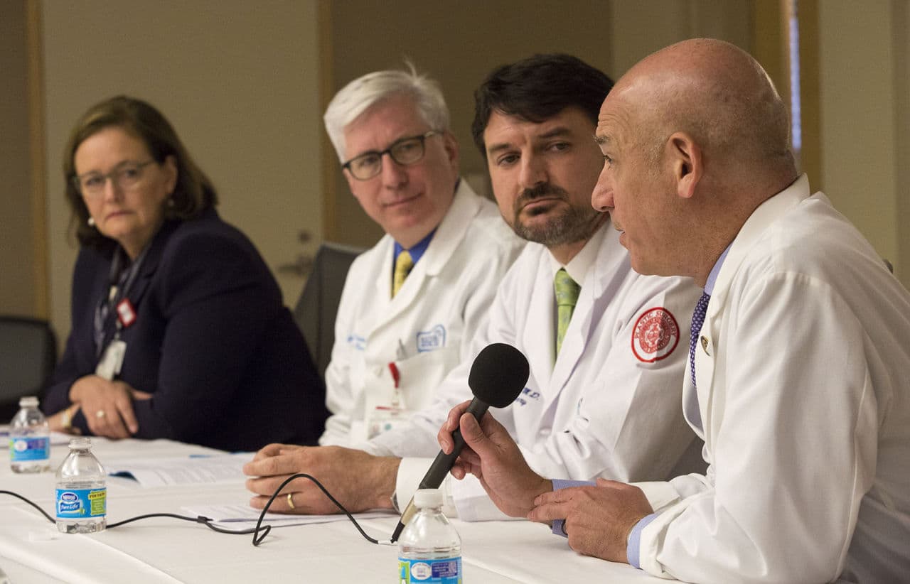 Dr. Joshua Safer speaks at a press briefing at Boston Medical Center as Kate Walsh, president and CEO of BMC, Dr. Gerard Doherty, chief of surgery, and Dr. Jaromir Slama, chief of plastic surgery look on. (Jesse Costa/WBUR)