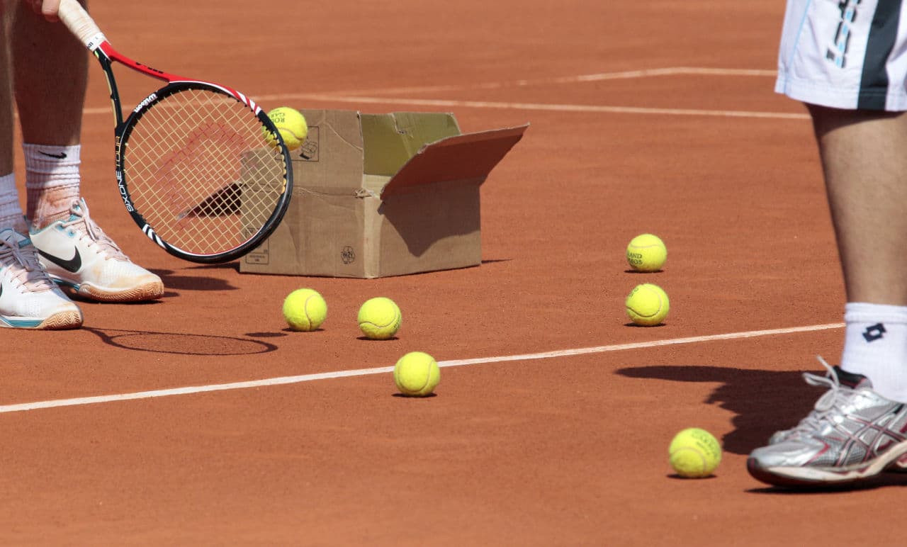 Players open a box of tennis balls during a training at Roland-Garros tennis stadium in Paris, on May 20, 2010, three days ahead of the French Open, the second Grand Slam tournament of the season. AFP PHOTO JACQUES DEMARTHON (Photo credit should read JACQUES DEMARTHON/AFP/Getty Images)