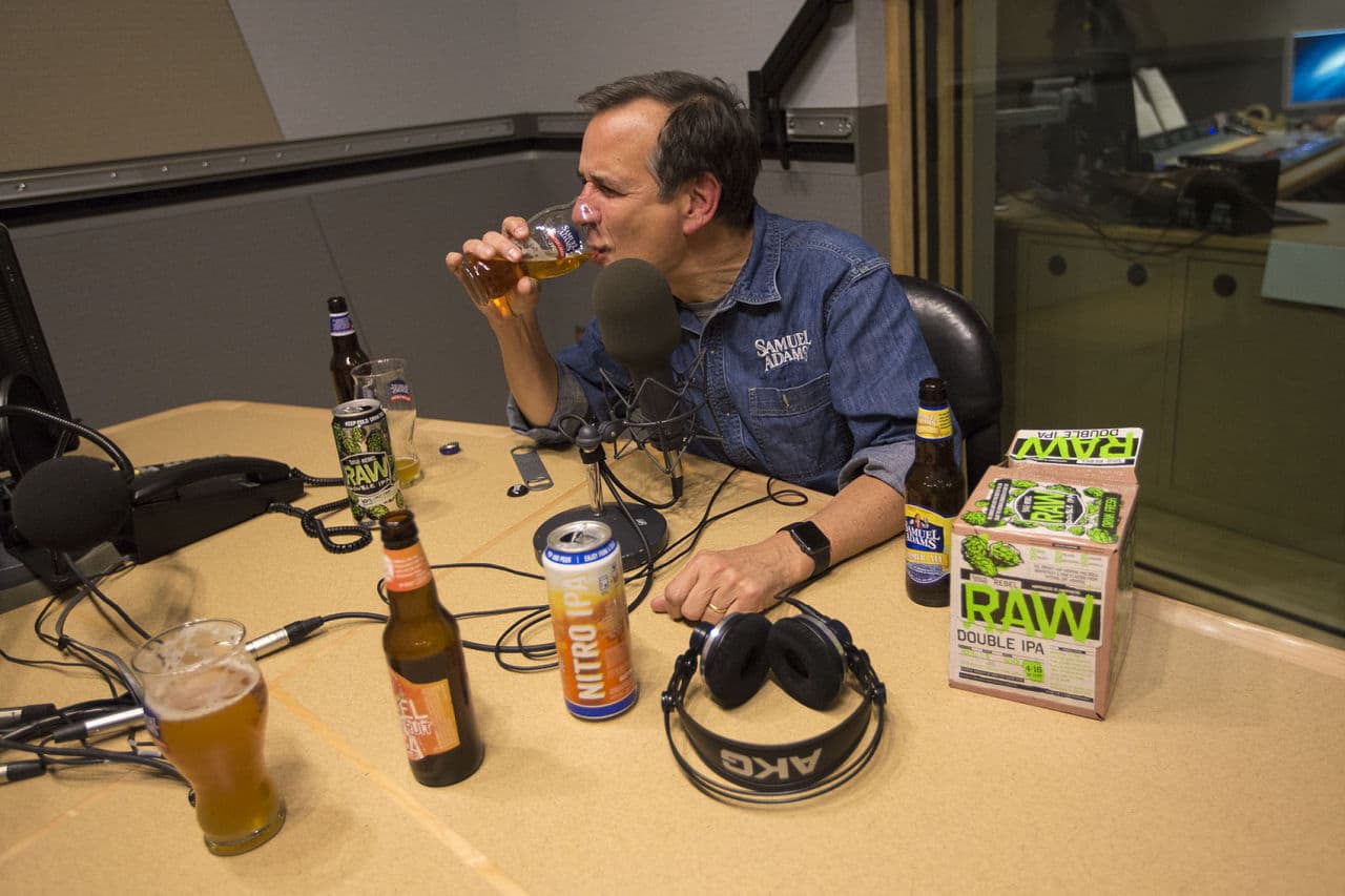 Jim Koch, founder of Boston Beer Company, which brews Samuel Adams Beer, tastes a glass of Boston Lager at the WBUR studios. (Jesse Costa/WBUR)