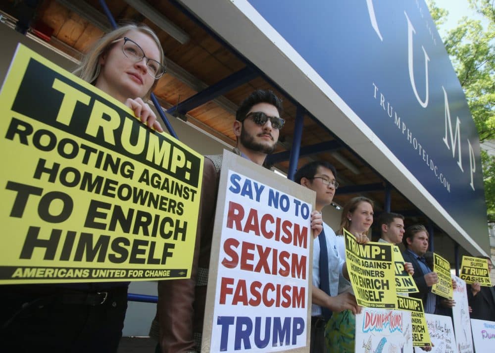 Protesters hold signs in front of Donald Trumps new Trump International Hotel to demand that he release his tax returns, May 24, 2016 in Washington, DC.  Protesters with the group Americans United For Change, challenged Trump to release his returns and reveal how much he profited off Americans misfortune during the housing crisis.  (Mark Wilson/Getty Images)