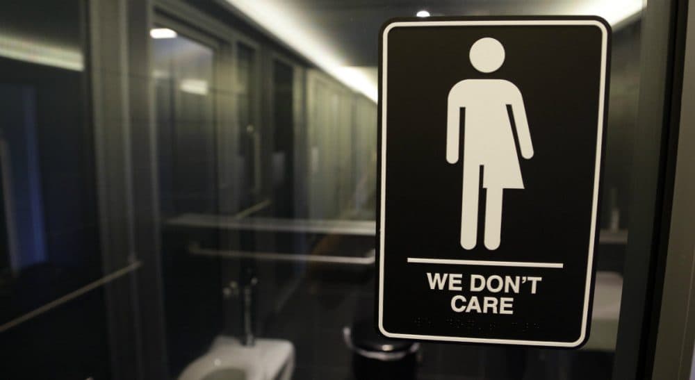 In this photo taken Thursday, May 12, 2016, signage is seen outside a restroom at 21c Museum Hotel in Durham, N.C. North Carolina is in a legal battle over a state law that requires transgender people to use the public restroom matching the sex on their birth certificate. The ADA-compliant bathroom signs were designed by artist Peregrine Honig. (Gerry Broome/AP)
