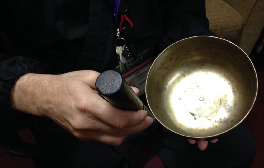 Seigan, a Buddhist chaplain, uses a Tibetan singing bowl while visiting hospital patients. (Courtesy/Karen Michel)