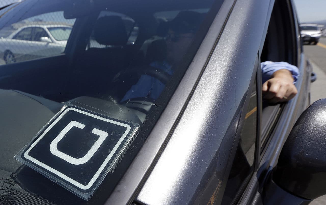 An Uber driver sits in his car near the San Francisco International Airport.
(AP Photo/Jeff Chiu, File)