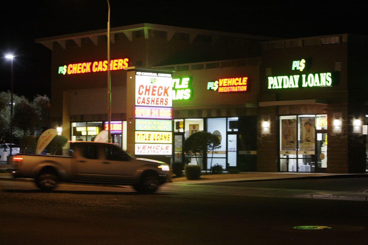 Neon signs illuminate this payday loan business, one of 650 operating in the state and some open 24 a day, Tuesday, April 6, 2010, in Phoenix. Attempts to reauthorize the payday loan industry failed in both houses of the Arizona legislature on Wednesday, as the industry operates on a temporary exemption from Arizona's 36-percent interest rate cap, but that exemption ends on June 30. (AP Photo/Ross D. Franklin)