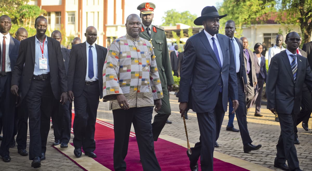 South Sudan's rebel leader and now Vice President Riek Machar, center-left, walks with President Salva Kiir, center-right, after being sworn in at the presidential palace in the capital Juba, South Sudan Tuesday, April 26, 2016. (Jason Patinkin/AP)