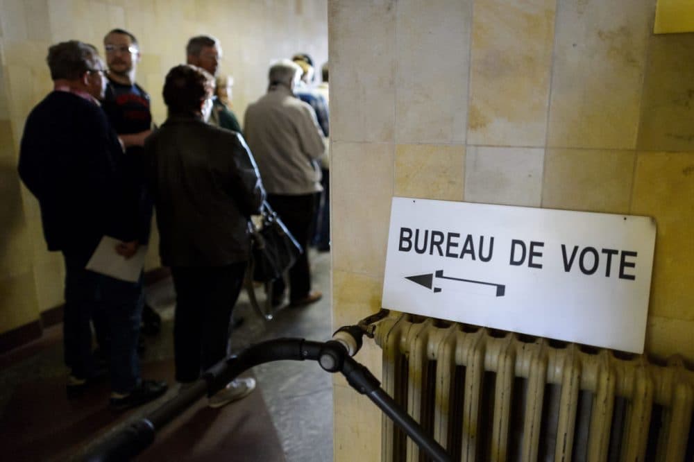 People queue to cast their ballot during a referendum on May 18, 2014 in Bulle, western Switzerland. (Fabrice Coffrini/AFP/Getty Images)