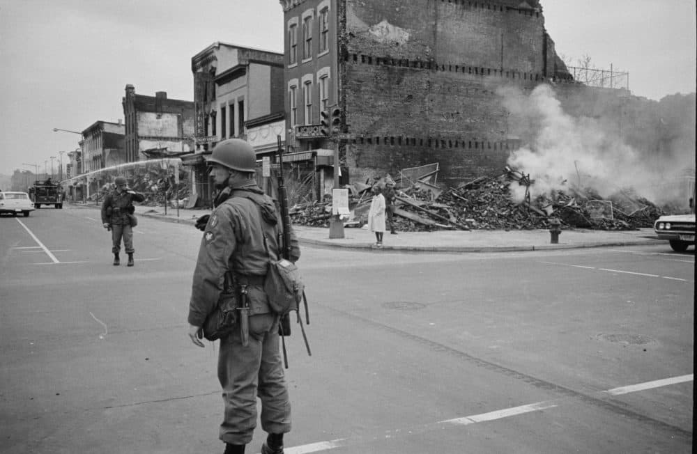 A soldier stands guard on the corner of 7th &amp; N Street NW in Washington D.C. on April 8, 1968 with the ruins of buildings that were destroyed during the riots that followed the assassination of Martin Luther King, Jr. (Warren K. Leffler/Library of Congress)