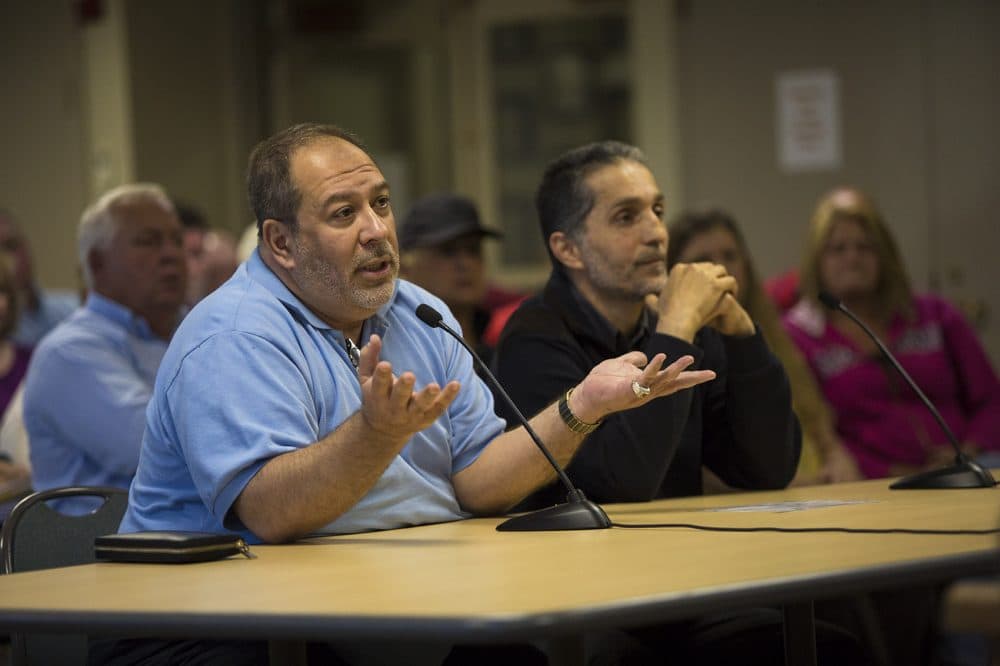 Dr. Amjad Bahnassi, left, chairman of the board of the Islamic Society of Greater Worcester, and civil engineer Imad Zrei ask questions during the Dudley Zoning Board of Appeals deliberations. (Jesse Costa/WBUR)