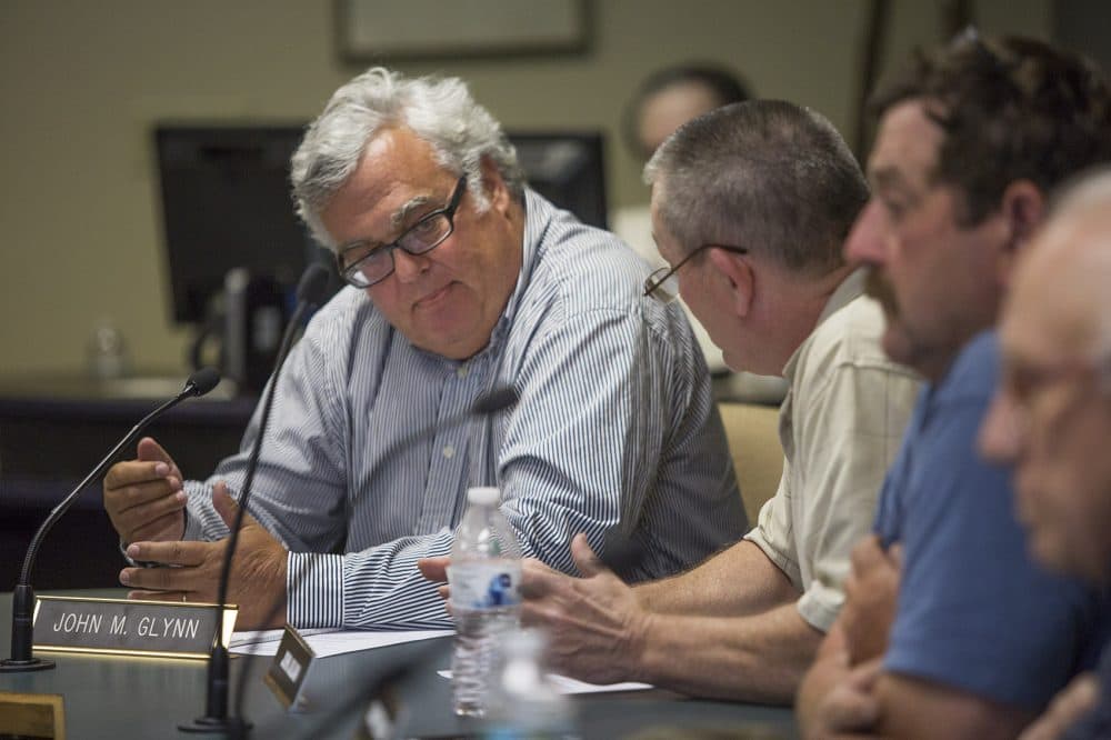Dudley Zoning Board of Appeals member John Glynn says to the other board members, “They have not been denied a special permit from acquiring a cemetery. They’ve been denied the ability to seek one, because they don’t have standing." (Jesse Costa/WBUR)