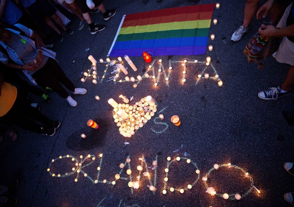 A message spelled out in candles is laid out at the vigil in Atlanta. (David Goldman/AP)