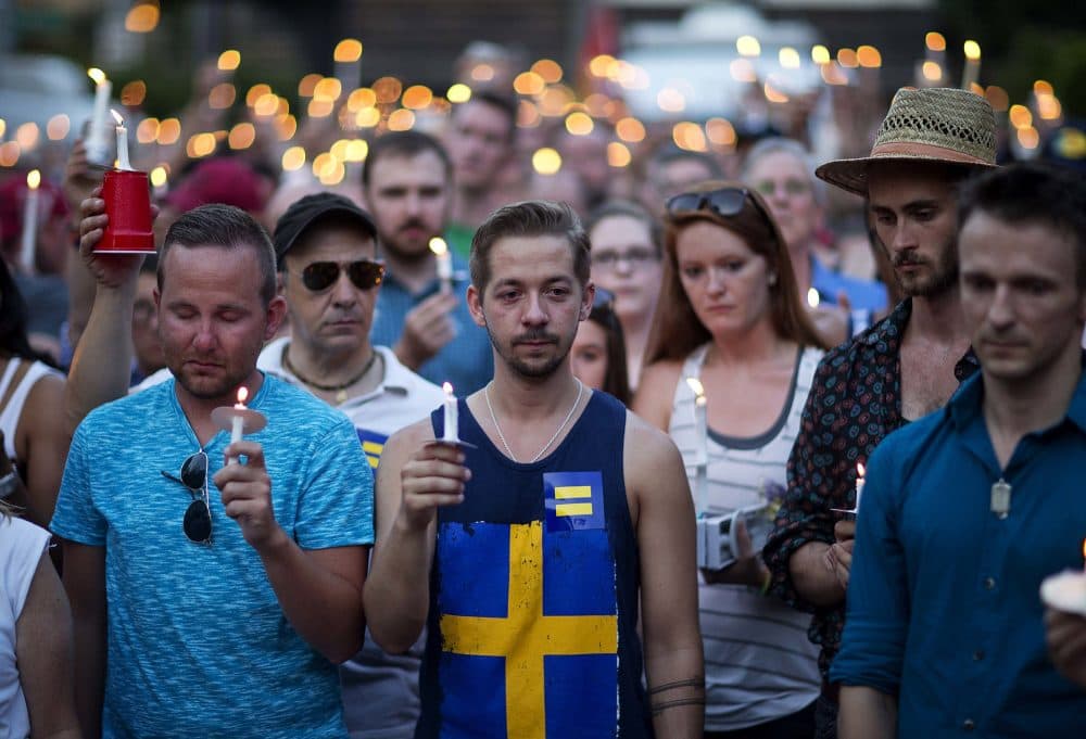 Mourners observe a moment of silence during a vigil for victims of the Orlando nightclub shooting on Sunday in Atlanta. (David Goldman/AP)