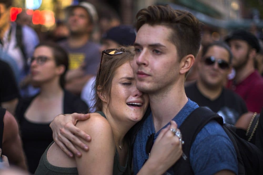 A woman cries in front of a makeshift memorial in New York to remember the victims of a mass shooting in Orlando, Fla. (Andres Kudacki/AP)