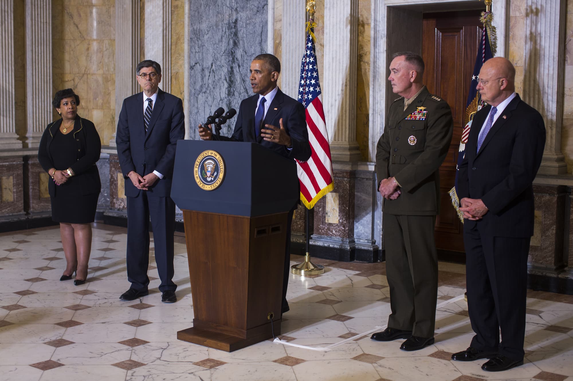 President Barack Obama (C) speaks on the Orlando shooting at the Treasury Department while Attorney General Loretta Lynch (L), Treasury Secretary Jack Lew (C-L), Chairman of the Joint Chiefs of Staff General Joseph Dunford (C-R) and Director of National Intelligence James Clapper (R) look on, on June 14, 2016 in Washington, DC. Obama directly attacked Donald Trump's proposal to ban Muslims from entering the United States. (Photo by Jim Lo Scalzo-Pool/Getty Images)