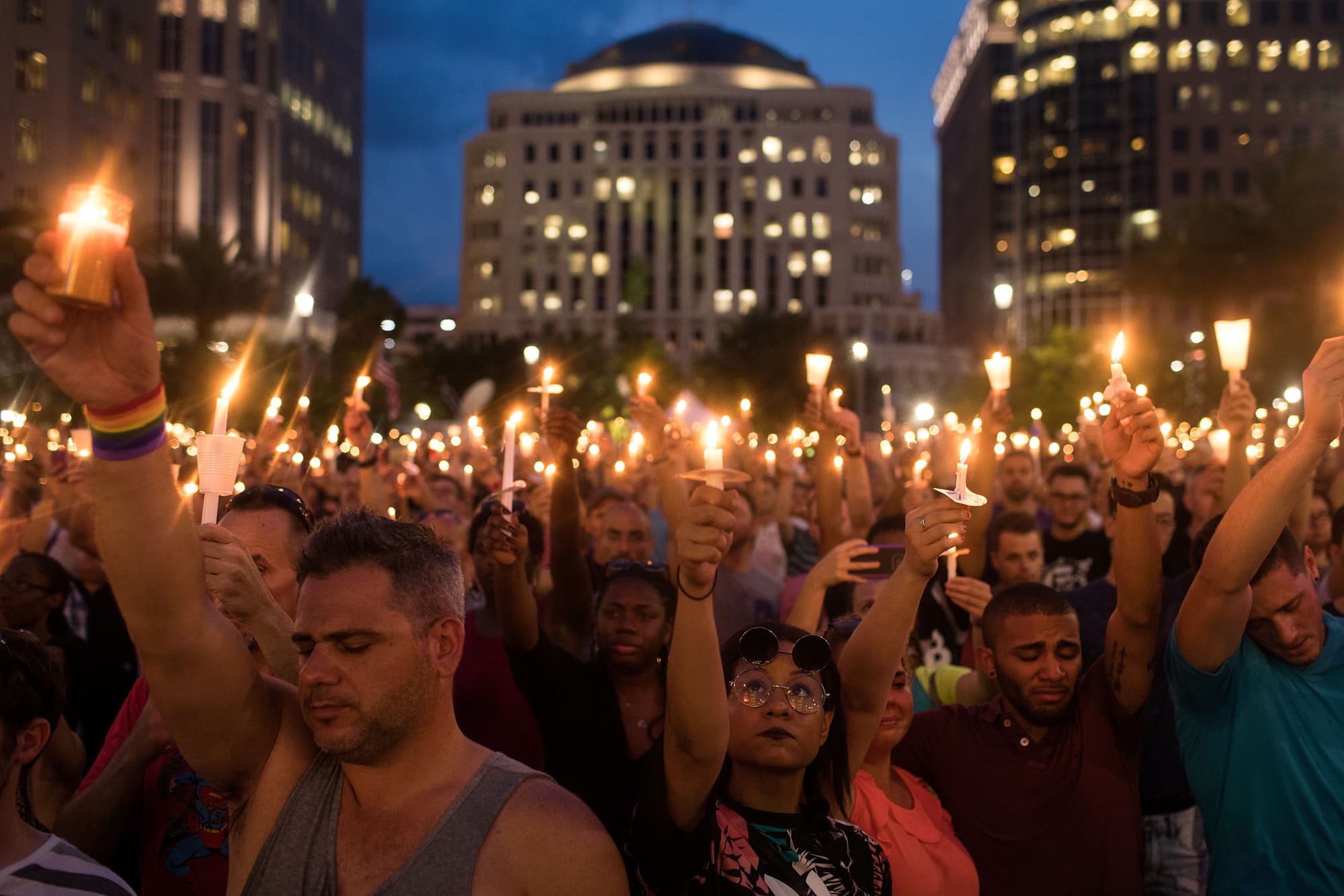 People hold candles during an evening memorial service for the victims of the Pulse Nightclub shootings, at the Dr. Phillips Center for the Performing Arts, June 13, 2016 in Orlando, Florida. The shooting at Pulse Nightclub, which killed 49 people and injured 53, is the worst mass-shooting event in American history. (Drew Angerer/Getty Images)