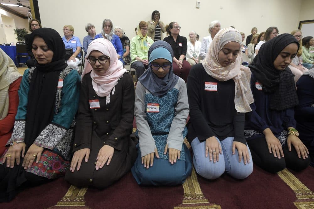 Non-Muslim members of the community watch a special prayer at the American Muslim Community Center Monday in Longwood, Fla., after the mass shooting at the Pulse Orlando nightclub. (Phelan M. Ebenhack/AP)