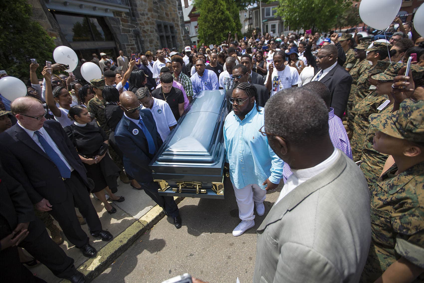 Pallbearers carry the casket of Raekwon Brown out of the Charles Street AME Church. (Jesse Costa/WBUR)