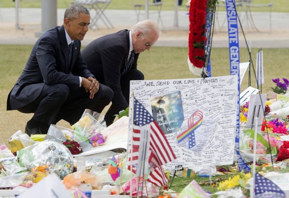 President Barack Obama and Vice President Joe Biden place flowers for the victims of the mass shooting at a gay nightclub Sunday at a memorial at the Dr. Phillips Center for the Performing Arts in Orlando, Florida, June 16, 2016. (Saul Loeb/AFP/Getty Images)