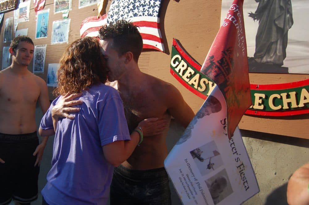 Lenny Taormina III is hugged by his mother Brenda after winning the St. Peter’s Fiesta Saturday Greasy Pole competition, June 25, 2016. &quot;I'm blessed to get this,&quot; he said of winning. (Greg Cook)