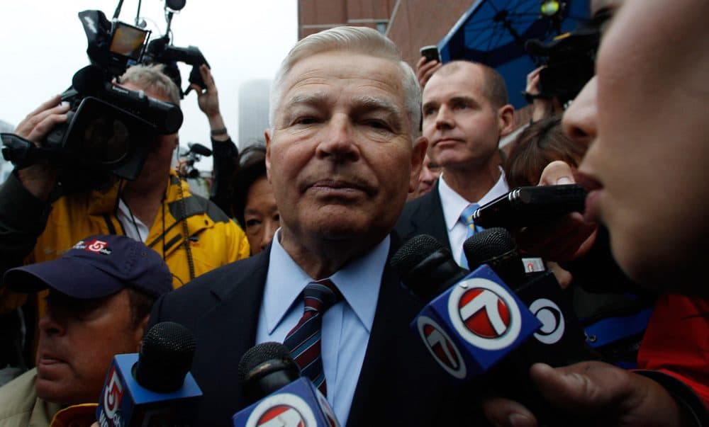 Former state Senate President William Bulger is escorted from Boston's federal courthouse after the first court appearance for his brother "Whitey" on June 24, 2011. (Charles Krupa/AP)