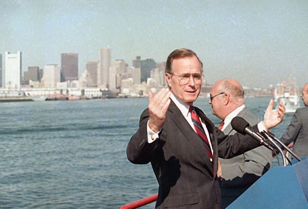 Vice President George H.W. Bush gestures while touring the Boston Harbor by boat, Sept. 1, 1988, during a brief campaign stop in Boston. Bush's campaign, which labeled Boston Harbor as &quot;the dirtiest harbor in America&quot; served as a catalyst for the clean up of the waters. (Peter Southwick/AP)