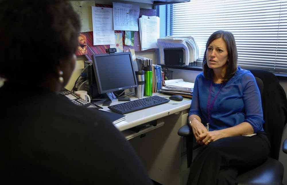 Social worker Cynthia Kennedy, clinical coordinator of the Homicide Support Services Project at Beth Israel Deaconess Medical Center, speaks with Worrell. (Robin Lubbock/WBUR)