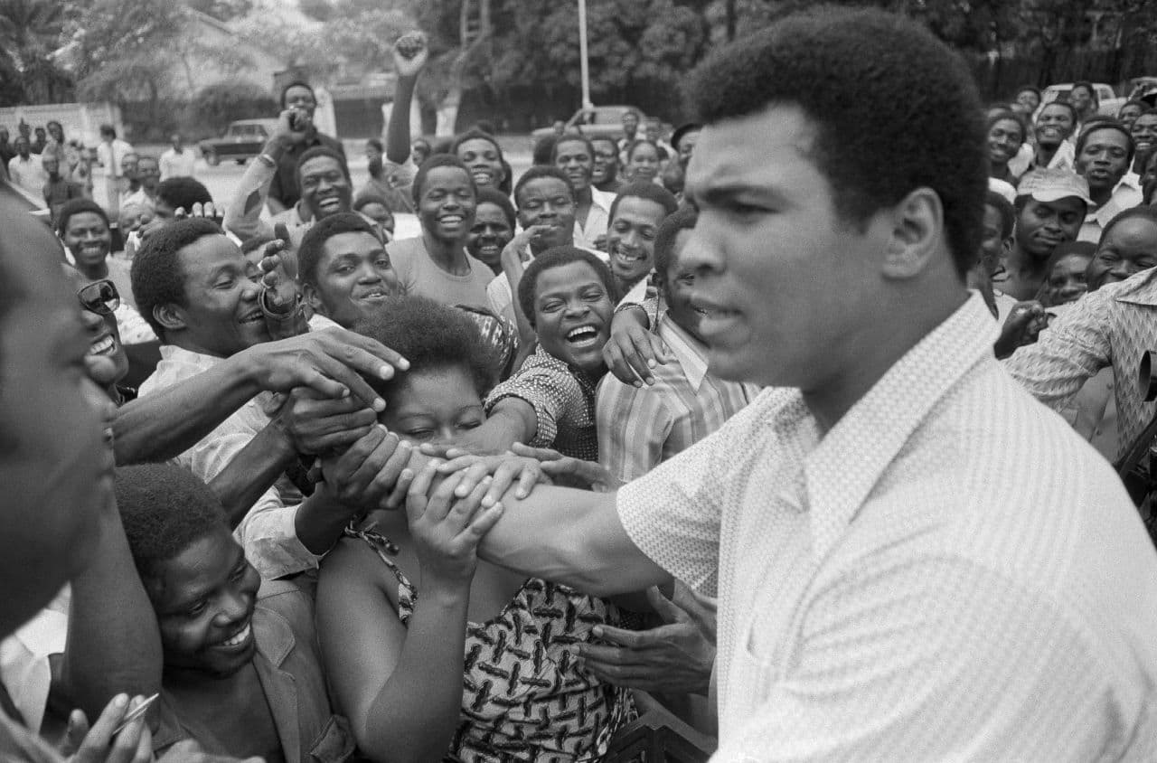In this Sept. 17, 1974, file photo, Muhammad Ali is greeted in downtown Kinshasa, Zaire. (AP)