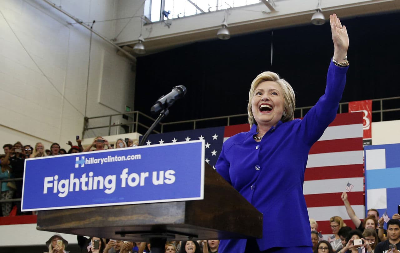 Eight years after conceding she was unable to "shatter that highest, hardest glass ceiling," Hillary Clinton is embracing her place in history as she finally crashes through as the presumptive Democratic presidential nominee. Here, she takes the stage at a rally on Monday. (John Locher/AP)