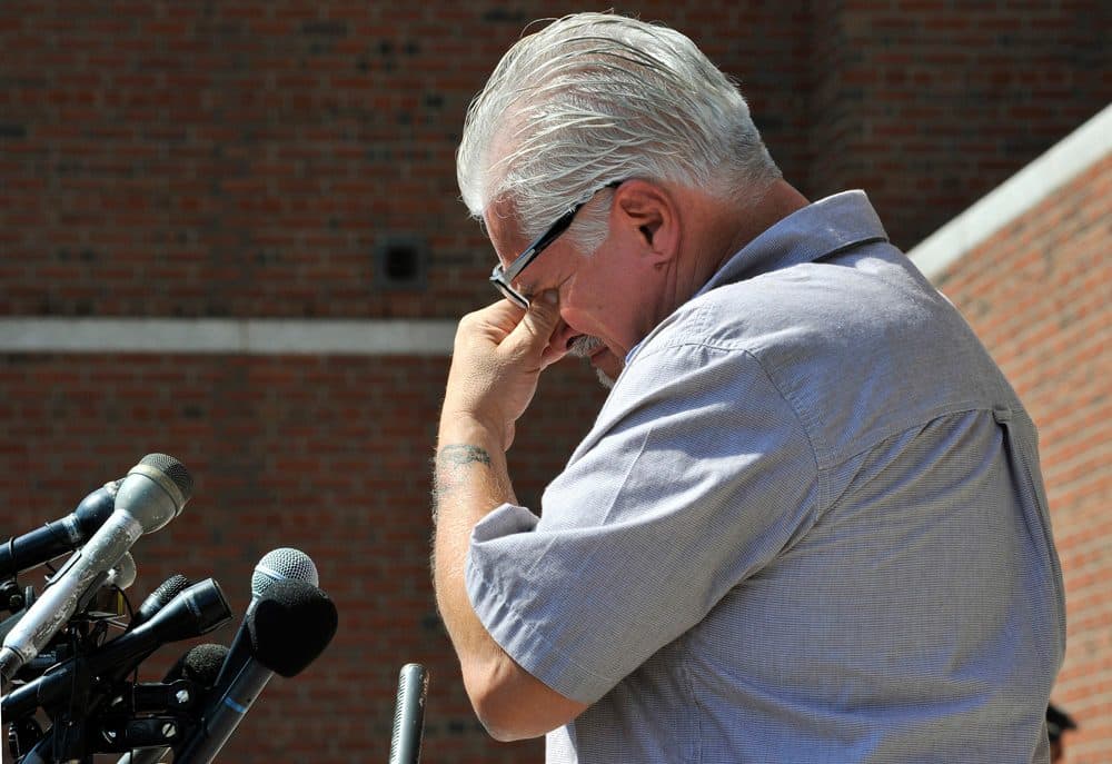 Stephen Davis, brother of murder victim Debra Davis, cries outside of Boston federal court while speaking with reporters. (WBUR)