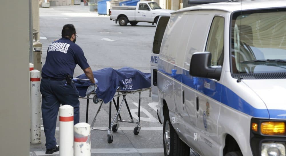 A person from the Los Angeles County Department of Medical Examiner-Coroner's office removes a body at the scene of a fatal shooting at the University of California, Los Angeles, Wednesday, June 1, 2016, in Los Angeles. (Nick Ut/AP)