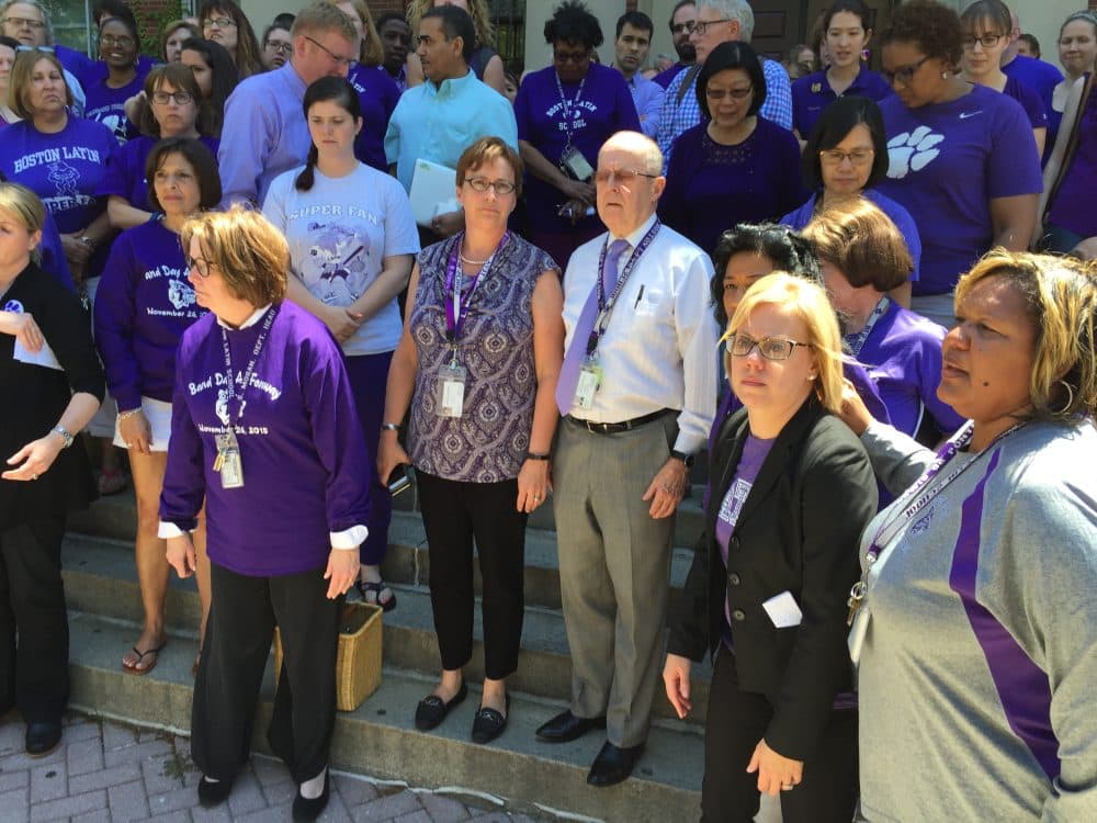 Boston Latin School Headmaster Lynn Mooney Teta and Assistant Headmaster Malcolm Flynn are stepping down after a series of racial incidents at the school. Faculty and staff gathered around them outside the school. (Lynn Jolicoeur/WBUR)